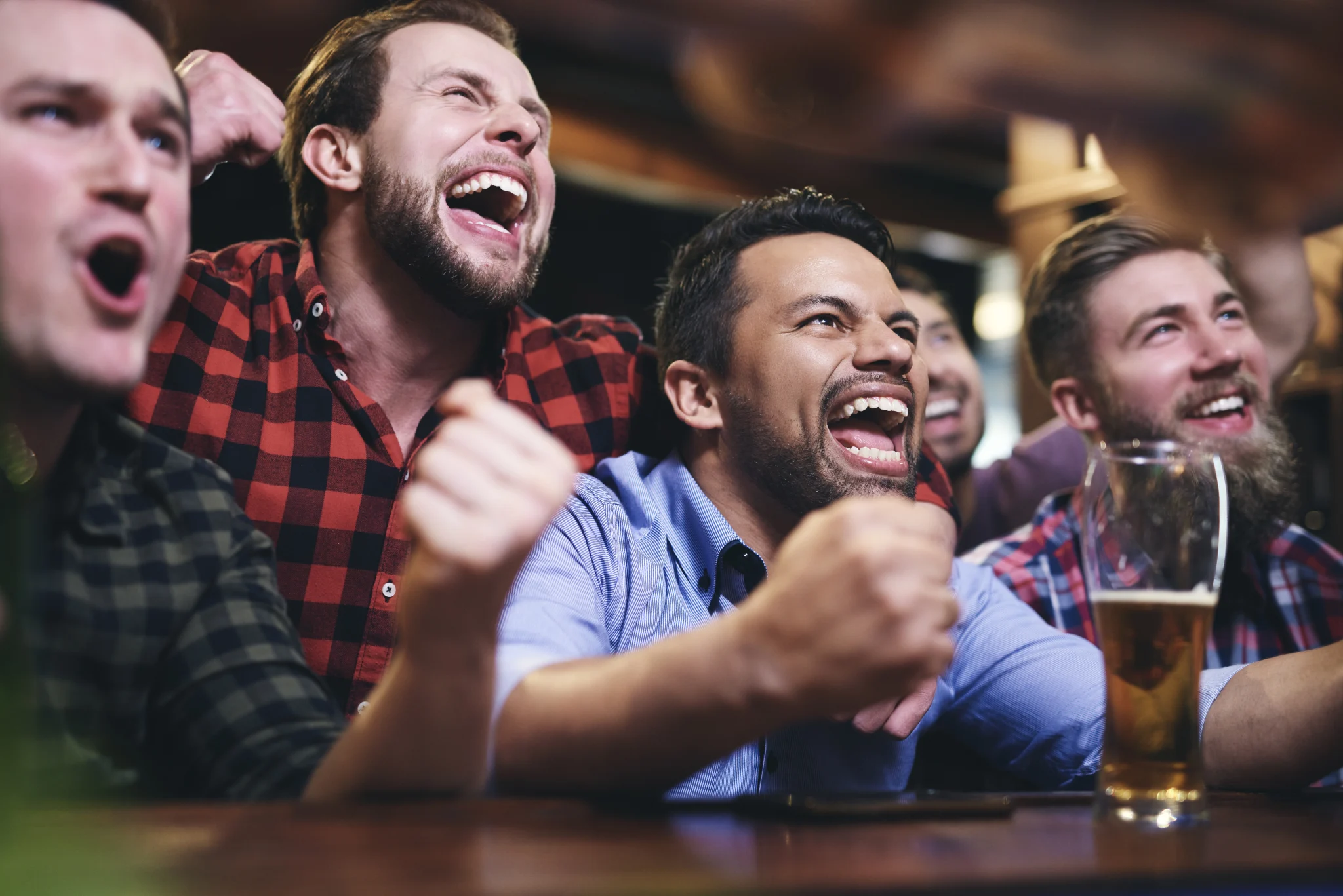 HOME men watching television cheering team